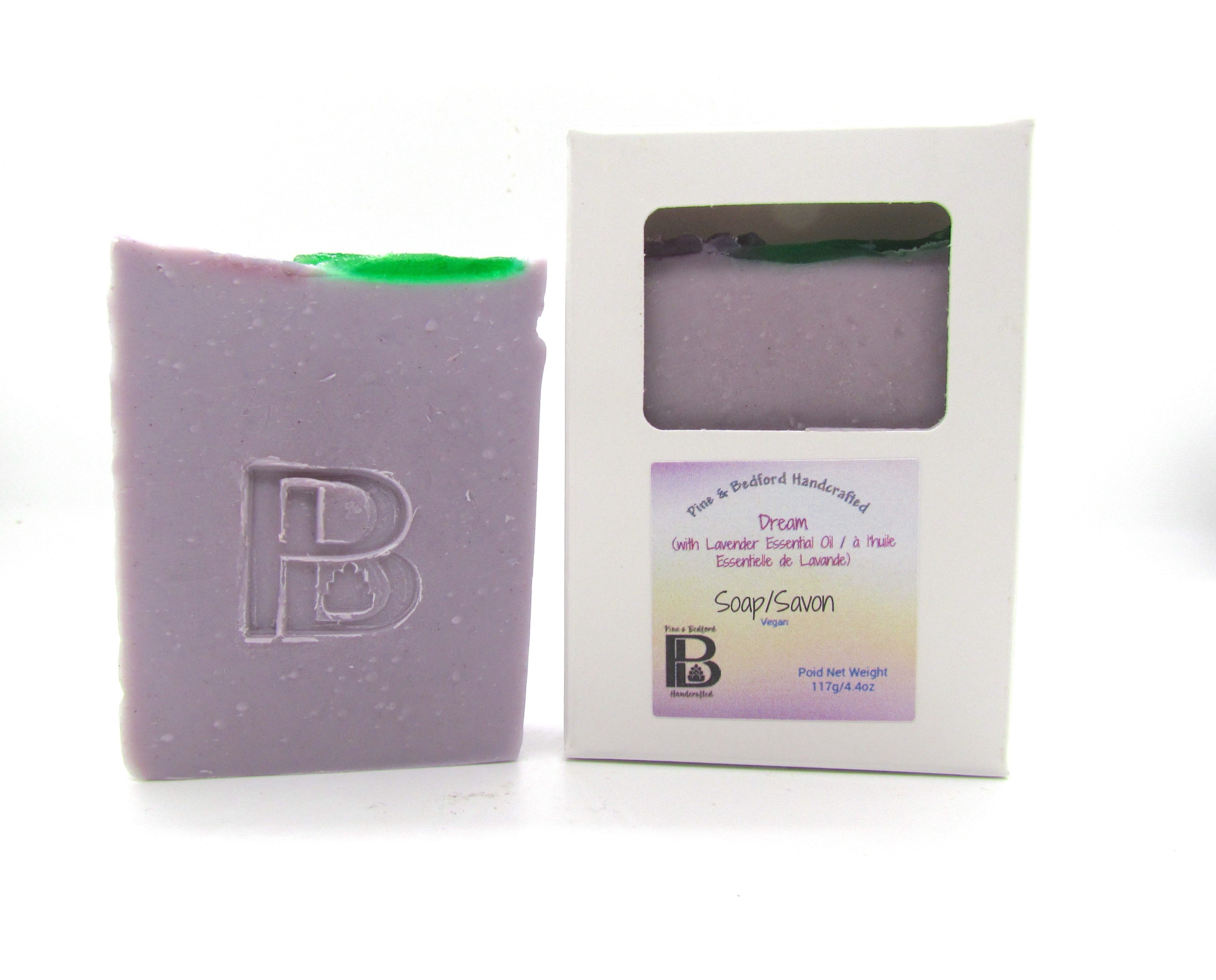 Pine and Bedford's Dream Soap is a cold process soap that is  coloured with Brazilian purple clay and embellished on top with green and purple lavender flowers made from glycerin soap.  Fragranced with Lavender essential oil. Shown here naked and also boxed.