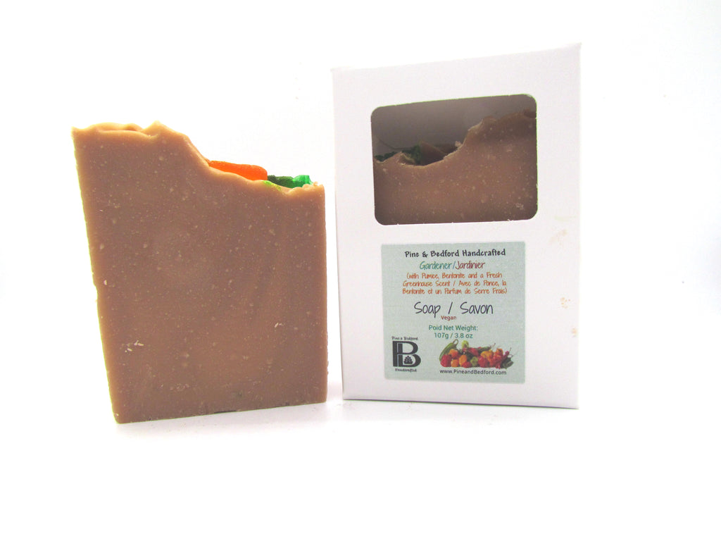 Pine and Bedford's Gardener's Soap made with Bentonite Clay and fine Pumice to clean and exfoliate.  This soap is a sandy-dirt-brown colour with a glycerine carrot embellishment on the top.  The fragrance is a delicious greenhouse blend with green foliage and earthy undertones.  Awesome.  This makes a great gift. Shown here naked and boxed.