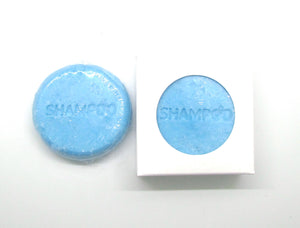 Pine and Bedford's  Solid Conditioning Shampoo Bar. A turquoise blue round solid bar with the word 'shampoo' stamped on the top. Available in two fragrances, and three sizes. Shown here naked and also boxed.