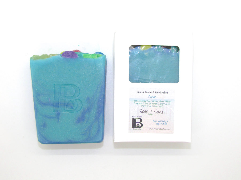 Pine and Bedford's Ocean bars are made from our Everyday Lather Formula and have added Sea Moss. Sea Moss is chock full of vitamins and nutrients that can be absorbed through the skin.  Ocean is a blue and green swirl soap with top embellishments made from Glycerine. Shown here naked and boxed.