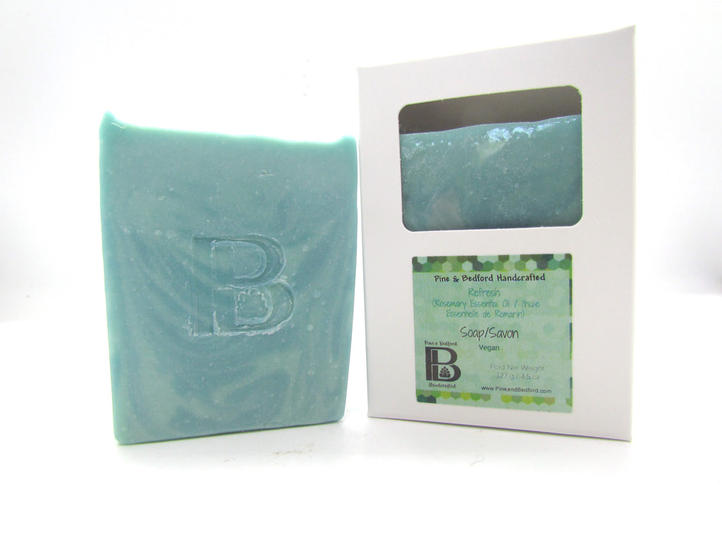 Pine and Bedford's Refresh  is a swirled two tone blue-green soap made with Rosemary Essential Oil. Shown here naked and also boxed.