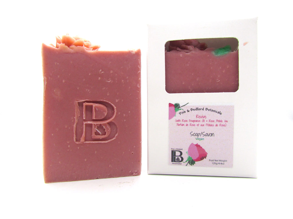 Pine and Bedford's Revive soap is a pink with top embellishments of rose, green foliage, and a line of white soapy pearls. A classic with a soft rose fragrance. Shown here naked and also boxed.