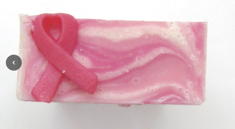 Pine and Bedford's Pink Ribbon Soap Bar showing the white and pink swirls and the breast cancer pink ribbon symbol made of soap on the top left of the bar. 